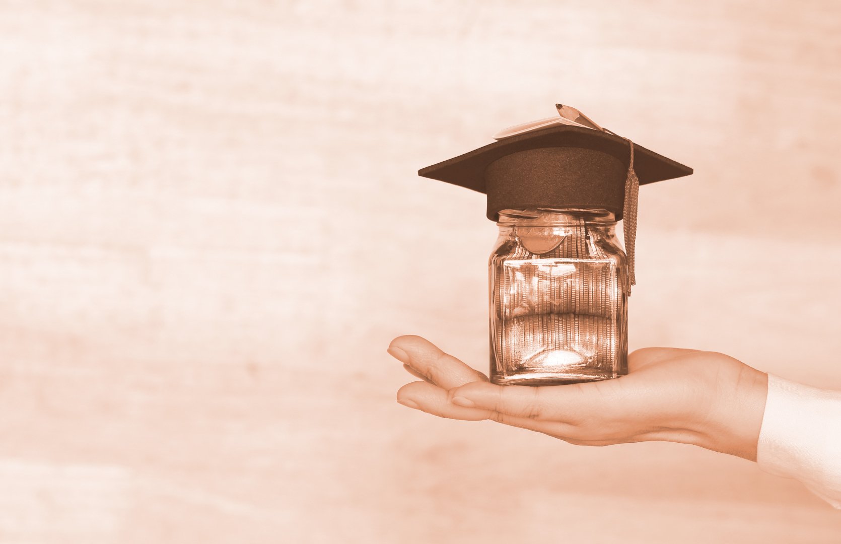 Header image of a hand with a jar full of coins and a greaduation cap on top of the jar