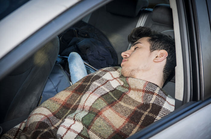 Man sleeping in his car