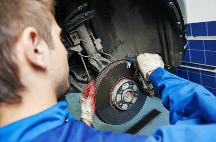 Mechanic looking at worn brakes