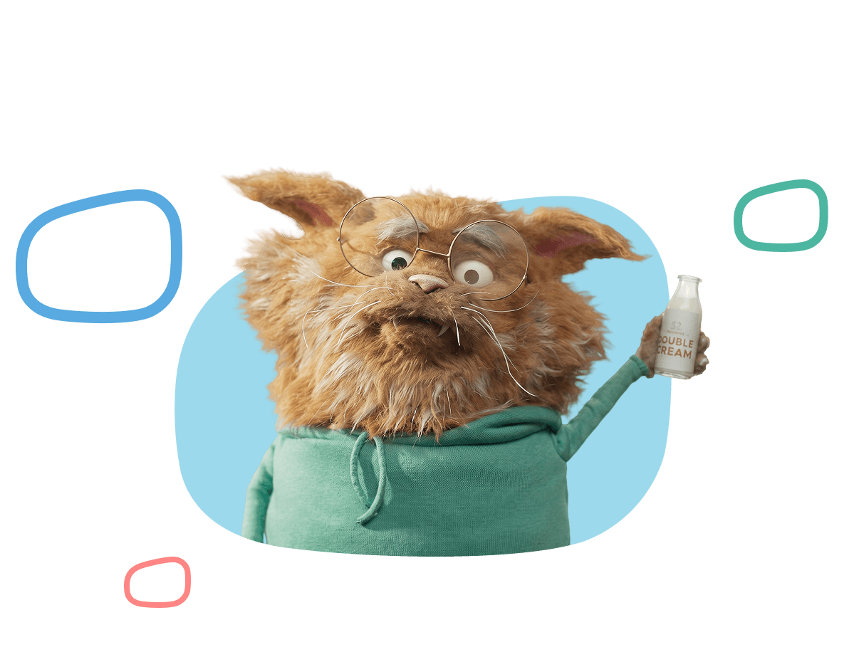 Furry orange creature with glasses wearing a green hoodie, holding a cream bottle, Just used Confused.com
