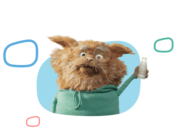 Furry orange creature with glasses wearing a green hoodie, holding a cream bottle, Just used Confused.com