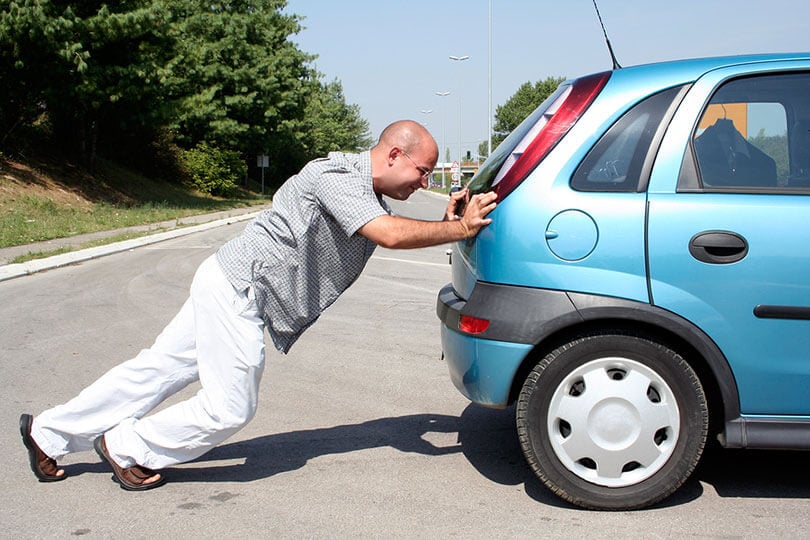 Man bump starting a car