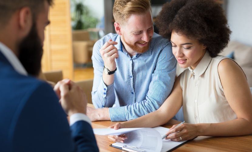 A header that says “Buy-to-let mortgage statistics: 2023” in bold black text on an orange background with an image of a couple signing a contract