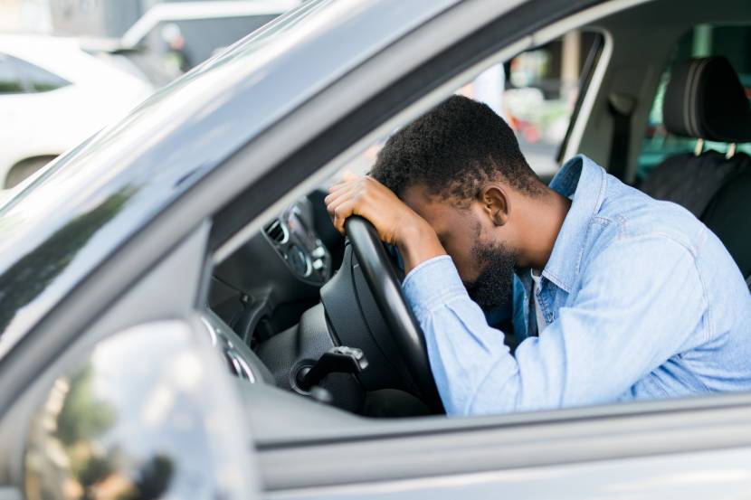 Person asleep in their car 