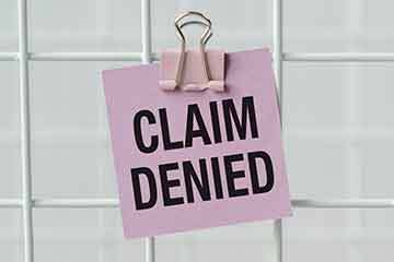 sticky note with claim denied written on it