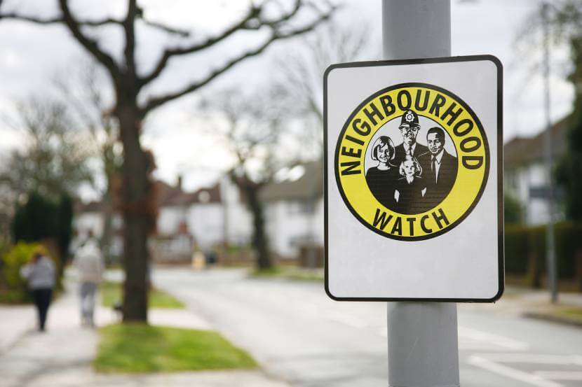 A Neighbourhood Watch sign attached to a lamppost in the street