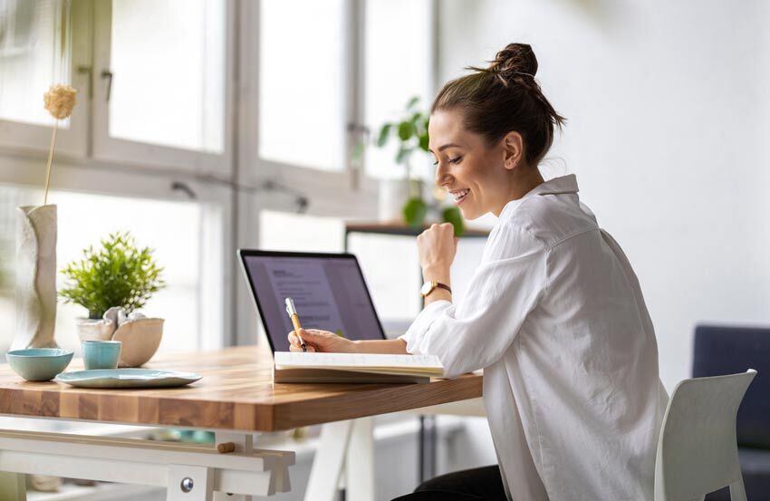 a lady working at a desk on a laptop