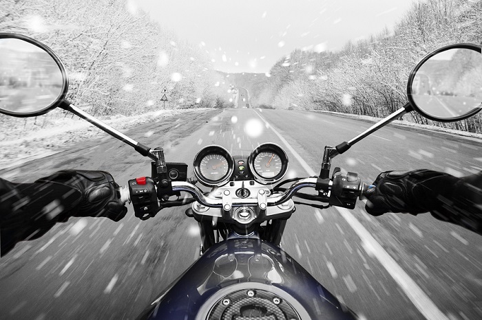 Person driving motorbike in winter