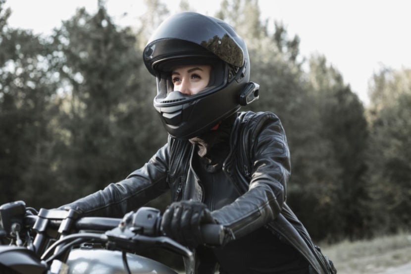 Someone wearing biking helmet and leathers riding a motorbike