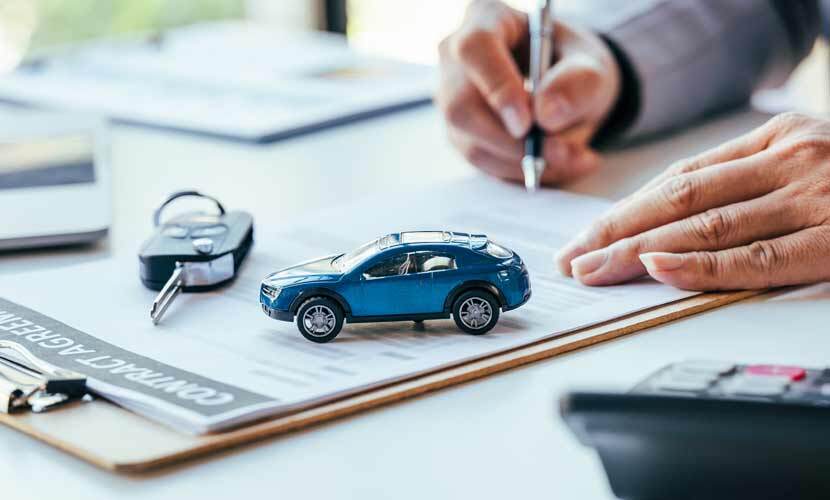Image of a toy car and someone filling out a form