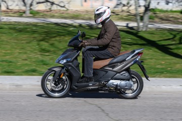 A motorcyclist drives their 50cc moped