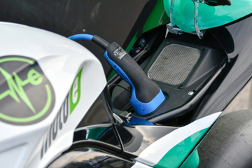 An electric motorbike being charged