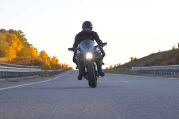 A motorcyclist rides on a road