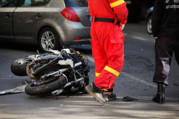 A motorbike on the floor after an accident with a car