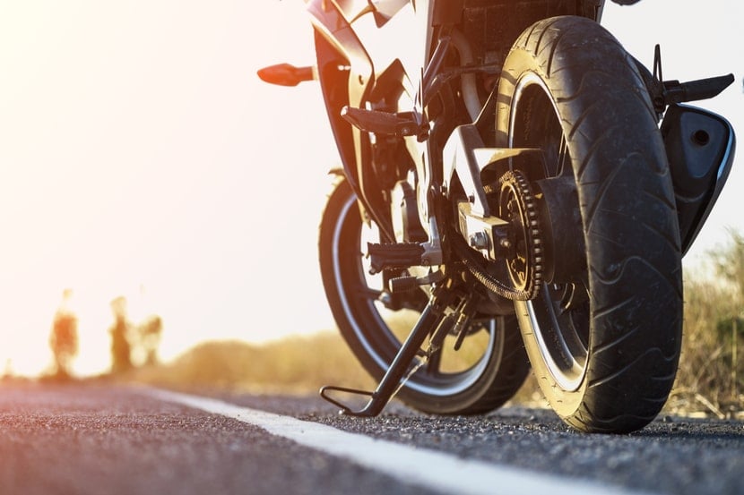 A close up of a motorbike parked on the road 