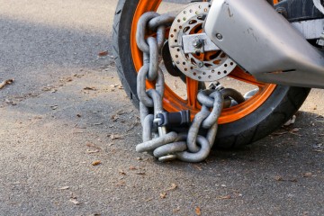 A chain attached to a motorbike for security 