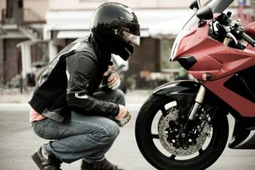 motorcyclist looking at bike article