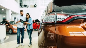A couple looking at car