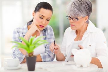 Mother and daughter looking at their finances together