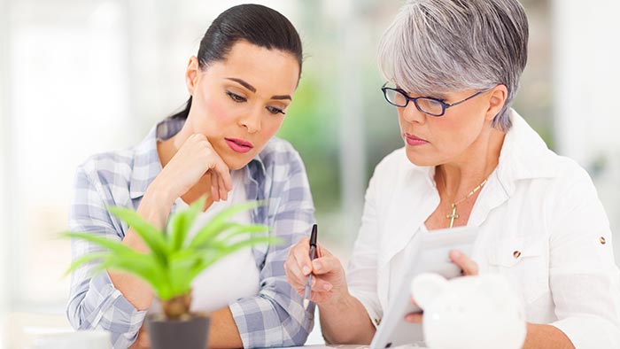 Mother and daughter looking at finances together