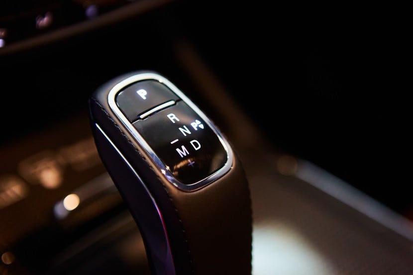 Automatic digital gear stick of a modern car with multimedia and navigation control buttons.
