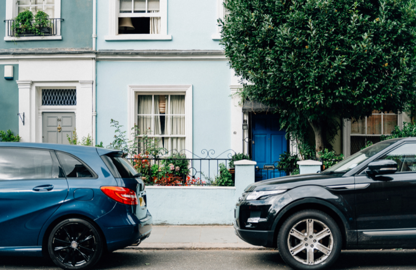 Two cars parked in front of house