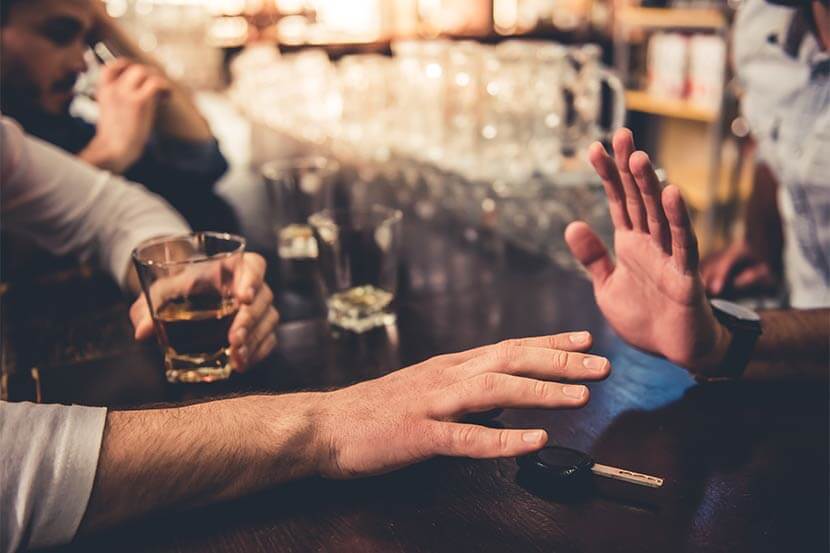 Bar staff stopping customer from drink driving