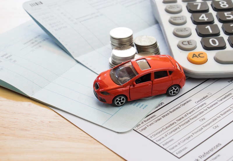 A model car on car insurance renewal documents