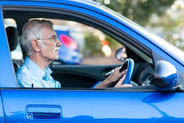 Elderly driver behind the wheel of their car