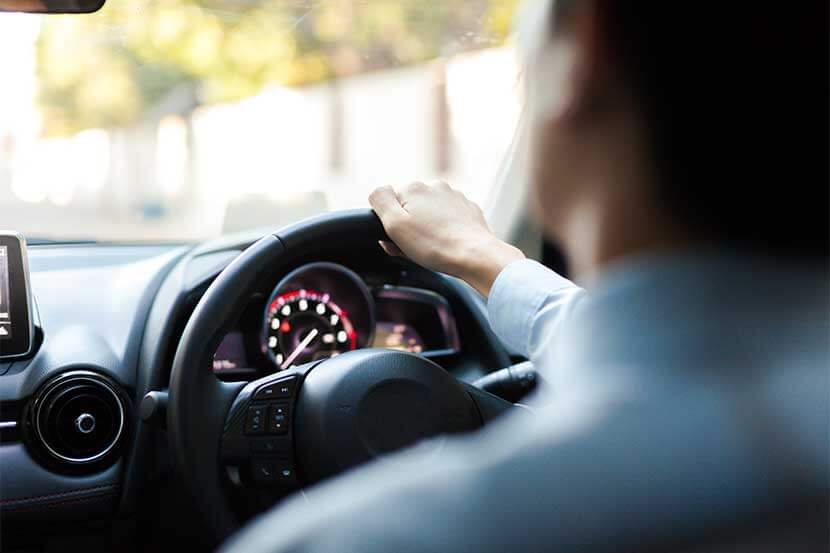 Close up of a man driving a car