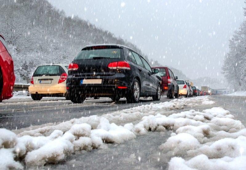 Traffic jam as cars drive in snow and ice