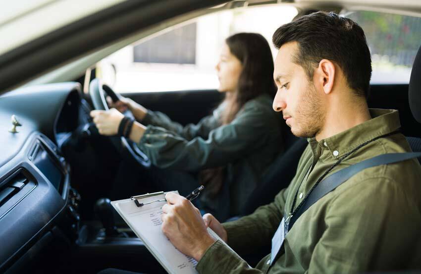 A learner driver and examiner in a car during a driving test