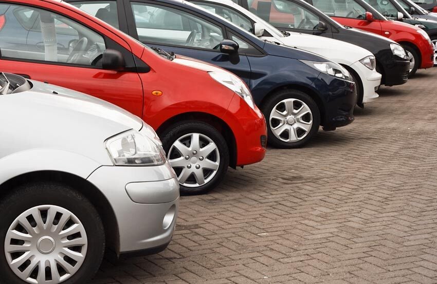 Side view of cars parked in a row