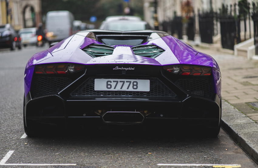 Purple car on road with number plate