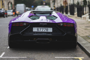 Purple car on road with number plate