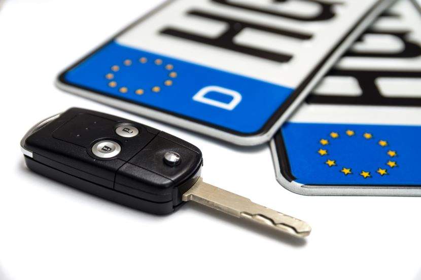 Car keys next to EU licence plates 