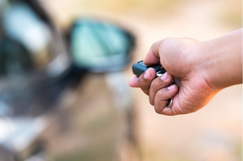 A driver opens their car with a keyless car key