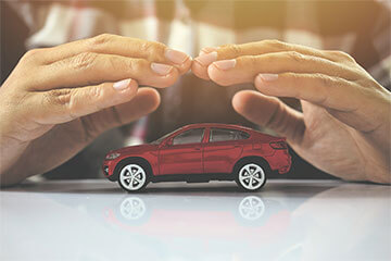 Model car being sheltered by hands