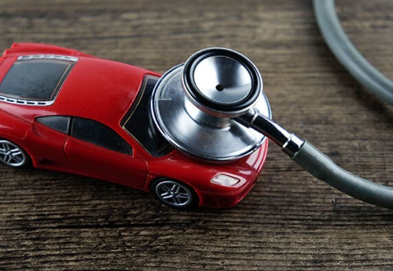 Small red model car with stethoscope  