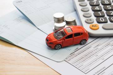 Model car surrounded by insurance items