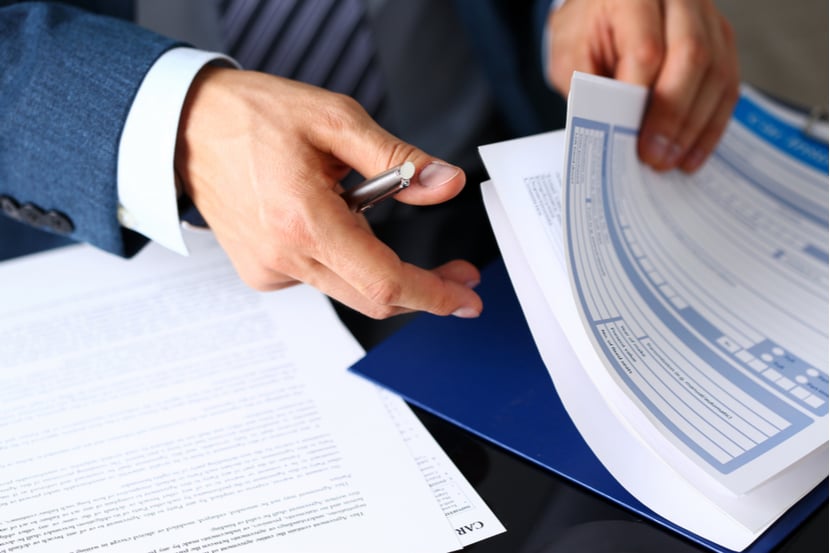 A lawyer looks through motor legal protection paperwork