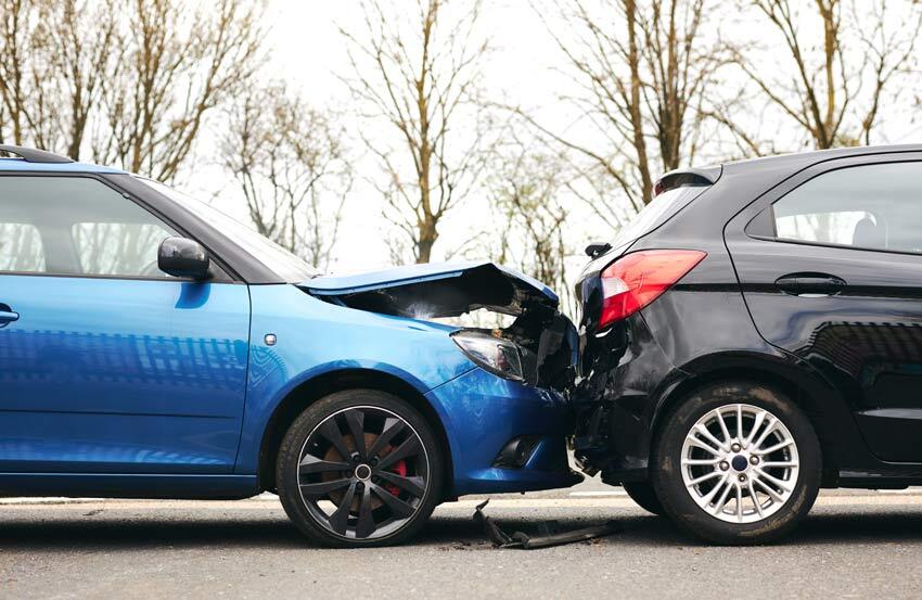 Two cars, one black, one blue, in a collision