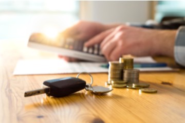 Person calculating car insurance premiums