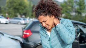 person holding neck after accident