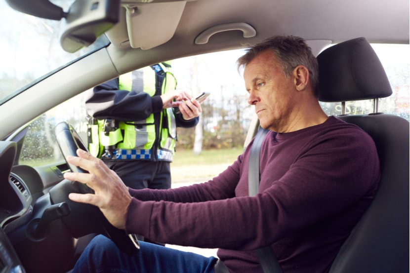 A driver being pulled over by a police officer for a driving offence
