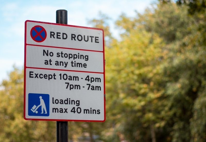 A red route sign in the UK