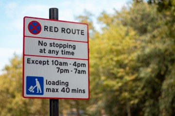 A red route sign in the UK