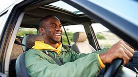 Smiling person driving in their car