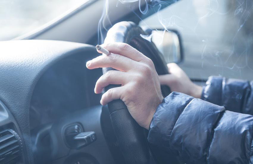 person smoking while driving