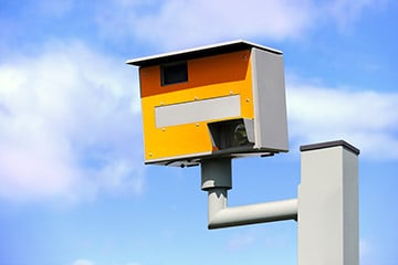 A speed camera attached to a gantry 